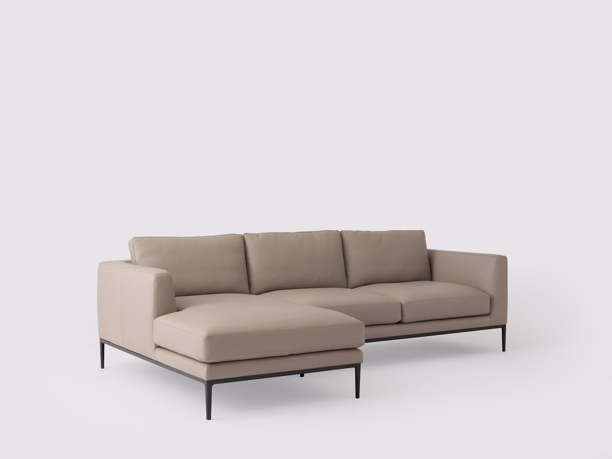 Angled view of the Oma modern sectional couch in grey leather